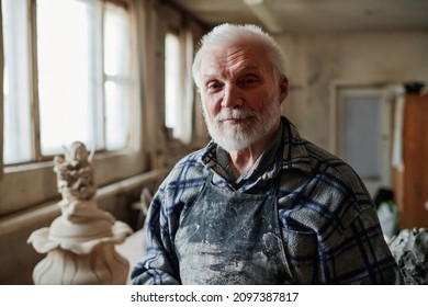 Senior Potter Working In Workshop