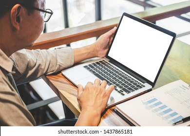 Senior professional businessman in casual wear working using laptop in cafe with business working connecting to wireless via computer, blank screen. - Shutterstock ID 1437865181