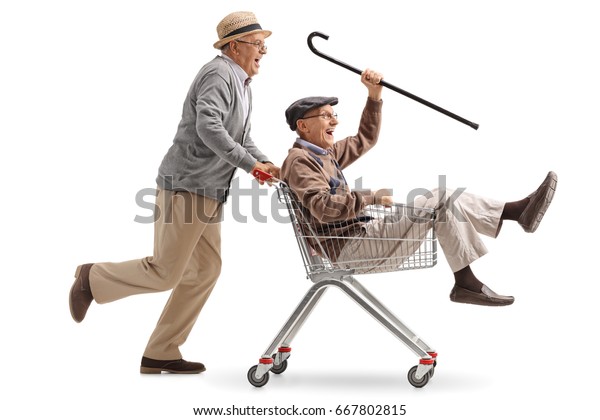 Senior pushing another senior in a shopping cart isolated on white background