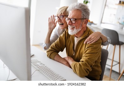 Senior Retired Couple Learn About Computer And Online Support.
