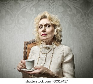 Senior Rich Woman Having A Cup Of Tea