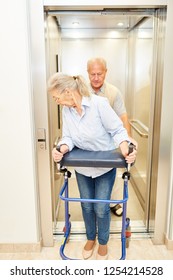 Senior With Rollator And Senior Man In An Elevator In A Nursing Home