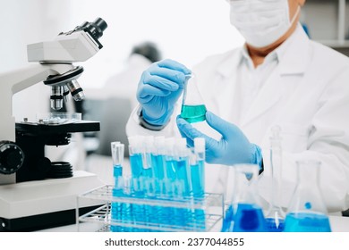 Senior scientists conducting research investigations in a medical laboratory, a researcher in the foreground is using a microscope in laboratory for medicine.  
 - Powered by Shutterstock