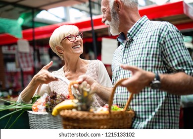 Senior Shopping Couple With Basket On The Market. Healthy Diet.