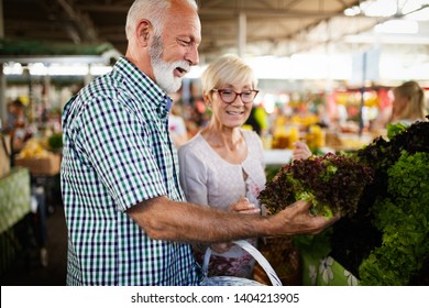 Senior Shopping Couple With Basket On The Market. Healthy Diet.