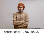 "Senior Sikh Man in Traditional Attire with Confident Pose"