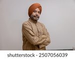 "Senior Sikh Man in Traditional Attire with Confident Pose"