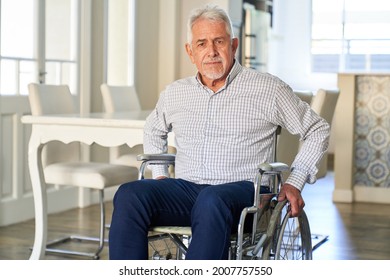 Senior Sitting In A Wheelchair In Rehab In A Retirement Home Or At Home After A Stroke