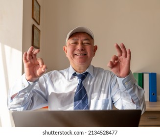 A Senior Smiling Businessman Giving The Ok Hand Sign After Closing A Big Business Deal.