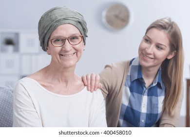 Senior Smiling Woman With Scarf On Head Fighting With Cancer With Her Daughters Help