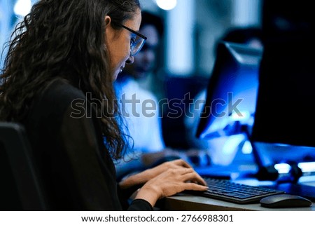 Senior software engineer debugging backend architecture code during agile sprint. Female developer reviewing syntax optimization strategy on digital screen.