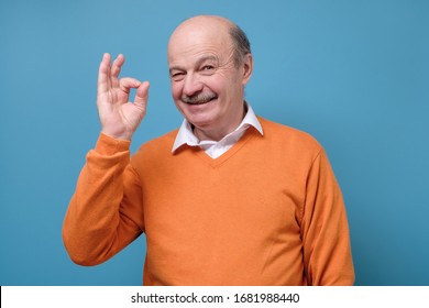 Senior Spanish Man Showing OK Sign Approving Choice. Studio Shot