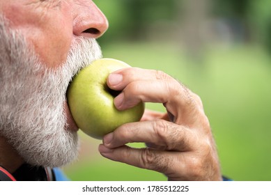 Senior Sportsman Eating Green Apple