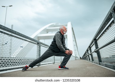 Senior Sportsman Warming-up Before A Run.