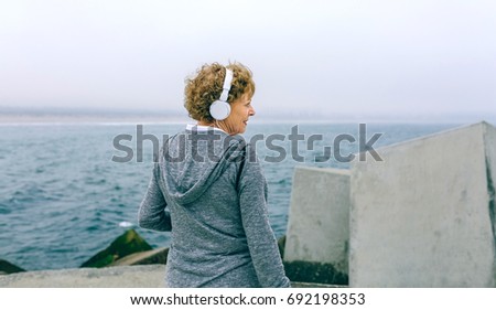 Similar – Senior sportswoman looking at the sea