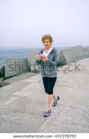 Similar – Two women walking by sea pier