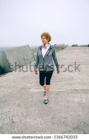 Similar – Two women walking by sea pier