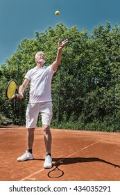 Senior Tennis Player Serving