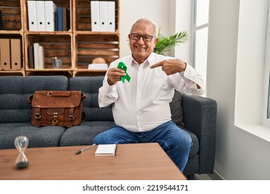 Senior Therapist With Grey Hair Holding Support Green Ribbon For Mental Health Awareness Pointing Finger To One Self Smiling Happy And Proud 