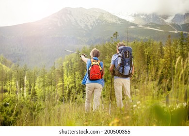 Senior Tourist Couple Hiking At The Beautiful Mountains