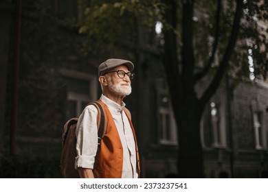 Senior tourist exploring new city, exploring interesting places. Elderly man with beret. Traveling and trips in retirement. - Powered by Shutterstock