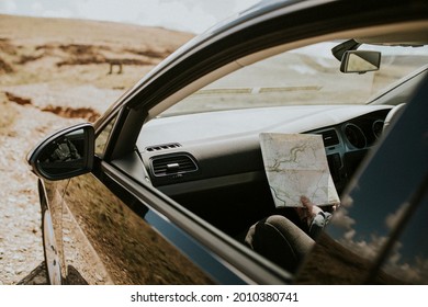 Senior Tourist Woman Looking At The Map In The Car