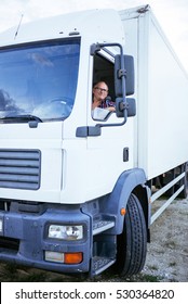 Senior Truck Driver Looking Through The Truck Window.