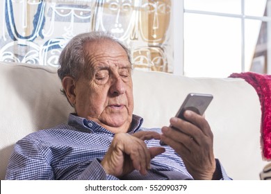 Senior Using A Smart Phone At Home
