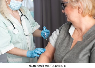 Senior Vaccination Concept. Elderly Getting Immune Vaccine At Arm For Flu Shot, Pneumonia, And Shingles In Hospital By Nurse. Doctor Giving An Injection To Older People Patient In Clinic