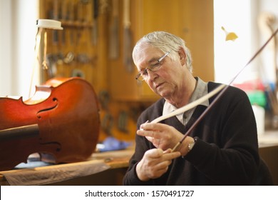 Senior Violin Maker Putting Hair On Violin Bow