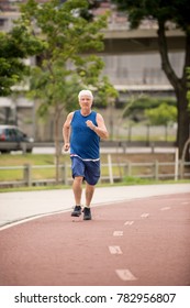 Senior Walking On A Street Racetrack As Physical Activity