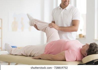 Senior ward undergoing pnf rehabilitation program led by a professional physiotherapist physiotherapist