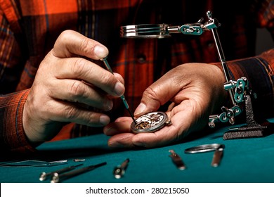 Senior watchmaker repairing an old pocket watch - Powered by Shutterstock