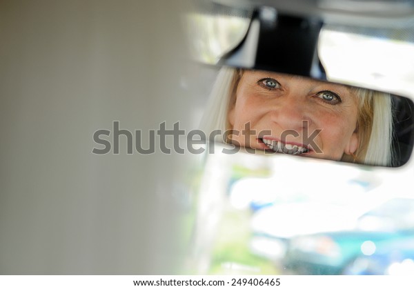 Senior At the Wheel\
looking in mirror