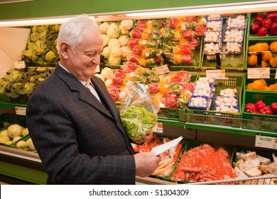 A Senior When Shopping For Food In The Supermarket