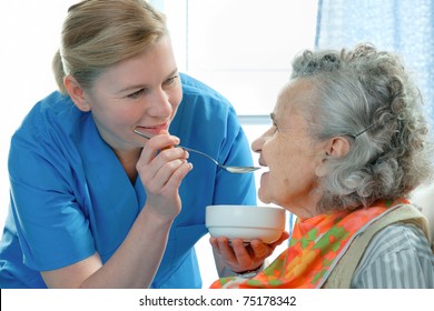 Senior Woman 90 Years Old Being Fed By A Nurse