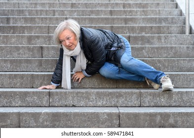Senior woman accidentaly falling down stone steps outdoors