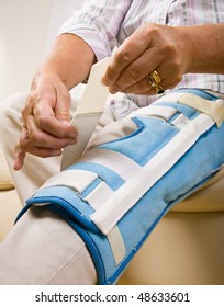 Senior Woman Adjusting Knee Brace