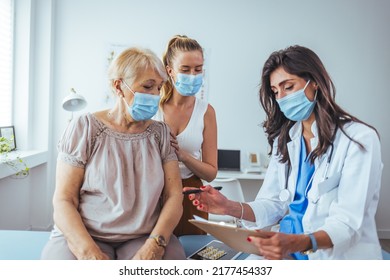 Senior Woman And Adult Daughter With Female Doctor. Professional Smiling Doctor Meeting A Senior Patient And Her Daughter At The Hospital, Medical Service Concept