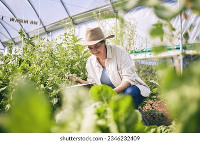 Senior woman, agriculture and greenhouse with plants, tablet for inspection, harvest and vegetable farming. Farmer, check crops and sustainability, agro business and ecology, growth and gardening - Powered by Shutterstock