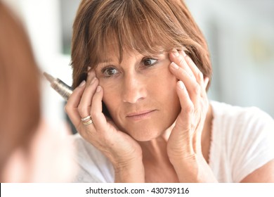 Senior Woman Applying Eye Concealer