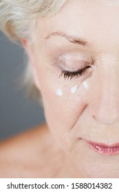 A Senior Woman Applying Eye Cream