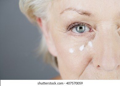 A Senior Woman Applying Eye Cream