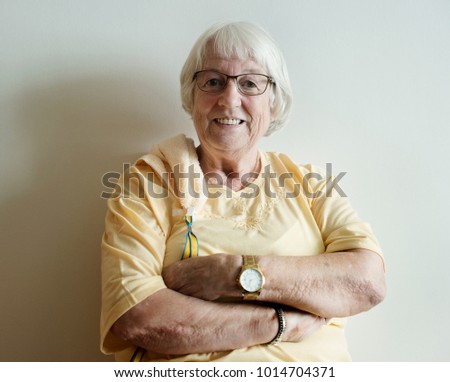 Similar – Image, Stock Photo Elderly woman in yellow top with a warm smile