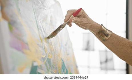 Senior woman artist's hands gracefully drawing on canvas in art studio, a lesson in creativity for mature students at the local academy - Powered by Shutterstock