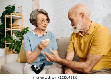 A senior woman assists her husband with diabetes management in their comfortable home. - Powered by Shutterstock