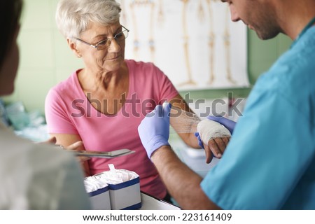 Senior woman with bandage on the hand 