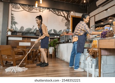 Senior woman and barista employee working at the workplace. family Small business owners coffee shop sweeping and mopping the floor, cafe entrepreneurs cleaning up cabinets. Restaurant tasks concept - Powered by Shutterstock