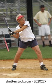 Senior Woman At Bat In Softball Game.