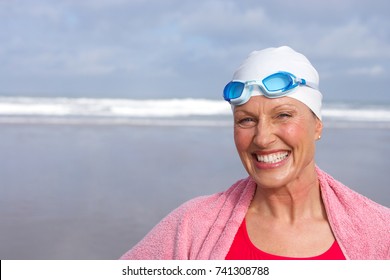 Senior Woman In Bathing Suit Smiling At Beach